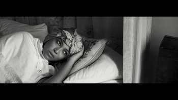Movie still from “Lemonade” (2016), directed by Mark Romanek – A young girl laying in bed with a pillow; Close Up shot, Overhead angle