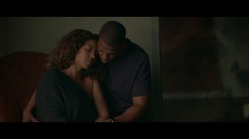 Movie still from “Lemonade” (2016), directed by Mark Romanek – A man and a woman embracing in a dark room; Medium shot, Overhead angle