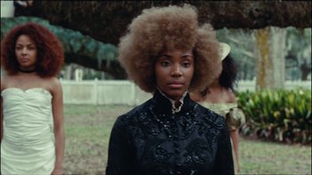 Movie still from “Lemonade” (2016), directed by Mark Romanek – A woman in a black dress with a large afro; Close Up shot, Over the shoulder angle