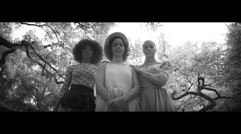 Movie still from “Lemonade” (2016), directed by Mark Romanek – A group of women standing next to each other in front of trees; Medium shot, Low angle