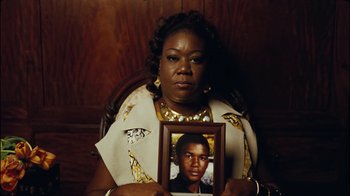Movie still from “Lemonade” (2016), directed by Mark Romanek – A woman holding a picture of a young man; Close Up shot, High angle