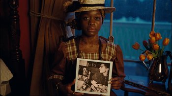 Movie still from “Lemonade” (2016), directed by Mark Romanek – A young girl holding up a picture of herself; Close Up shot, High angle