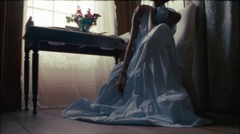 Movie still from “Lemonade” (2016), directed by Mark Romanek – A woman sitting on the ground in a dress; Medium shot, High angle