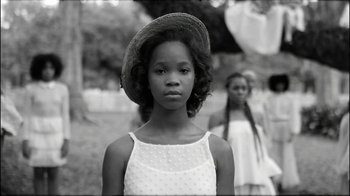 Movie still from “Lemonade” (2016), directed by Mark Romanek – A black and white photo of a young girl wearing a hat; Close Up shot, Low angle