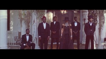Movie still from “Lemonade” (2016), directed by Mark Romanek – A group of men and a woman standing next to each other; Wide shot, Low angle
