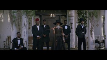 Movie still from “Lemonade” (2016), directed by Mark Romanek – A group of men standing in front of a building; Wide shot, Low angle