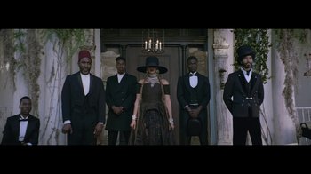 Movie still from “Lemonade” (2016), directed by Mark Romanek – A group of men and a woman standing next to each other in front of a building; Wide shot, Low angle