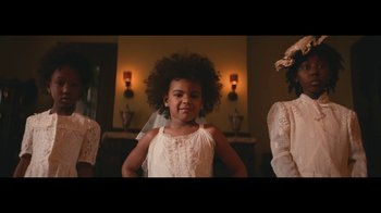 Movie still from “Lemonade” (2016), directed by Mark Romanek – A little girl in a white dress standing in front of a mirror; Medium shot, Low angle