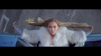 Movie still from “Lemonade” (2016), directed by Mark Romanek – A person wearing a white fur coat; Extreme Wide shot, Overhead angle