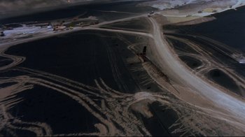 Movie still from “Lessons of Darkness” (1992), directed by Werner Herzog – An aerial view of an open pit mine; Extreme Wide shot, Overhead angle