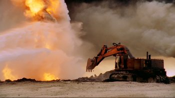 Movie still from “Lessons of Darkness” (1992), directed by Werner Herzog – An excavator is in the middle of a pile of rubble; Extreme Wide shot, Low angle