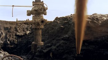 Movie still from “Lessons of Darkness” (1992), directed by Werner Herzog – An old fire hydrant on the side of a mountain; Extreme Wide shot, High angle