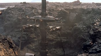 Movie still from “Lessons of Darkness” (1992), directed by Werner Herzog – An image of an oil well in the middle of the day; Extreme Wide shot, High angle