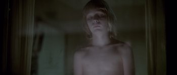 Movie still from “Let the Right One In” (2008), directed by Tomas Alfredson – A young boy is looking at the camera; Close Up shot, Low angle