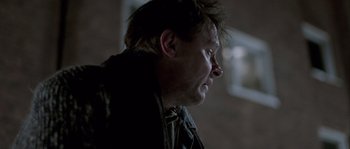 Movie still from “Let the Right One In” (2008), directed by Tomas Alfredson – A person looking down; Close Up shot, Over the shoulder angle