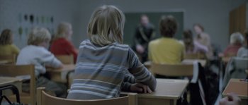 Movie still from “Let the Right One In” (2008), directed by Tomas Alfredson – A group of people sitting in a classroom; Medium shot, Over the shoulder angle