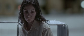 Movie still from “Let the Right One In” (2008), directed by Tomas Alfredson – A young woman with long black hair wearing a white shirt; Close Up shot, High angle