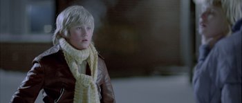 Movie still from “Let the Right One In” (2008), directed by Tomas Alfredson – A young boy wearing a leather jacket and a scarf; Close Up shot, Over the shoulder angle