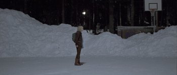 Movie still from “Let the Right One In” (2008), directed by Tomas Alfredson – A woman standing in the snow at night; Wide shot, Over the shoulder angle