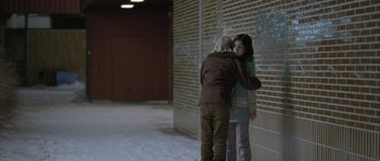 Movie still from “Let the Right One In” (2008), directed by Tomas Alfredson – Two people standing next to each other in a building; Wide shot, Over the shoulder angle
