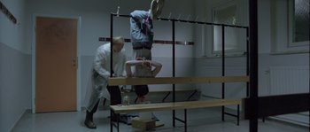 Movie still from “Let the Right One In” (2008), directed by Tomas Alfredson – Two men in white lab coats and a bench; Wide shot, High angle