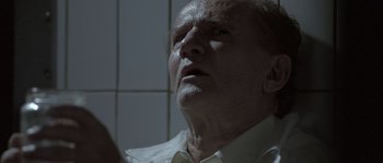 Movie still from “Let the Right One In” (2008), directed by Tomas Alfredson – An older man looking up into the ceiling; Close Up shot, Low angle