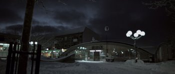 Movie still from “Let the Right One In” (2008), directed by Tomas Alfredson – A night time scene of a building and a street light; Extreme Wide shot, Low angle