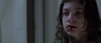 Movie still from “Let the Right One In” (2008), directed by Tomas Alfredson – A young girl with blood on her mouth; Close Up shot, Low angle