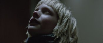 Movie still from “Let the Right One In” (2008), directed by Tomas Alfredson – A person's face with long blonde hair; Close Up shot, Low angle