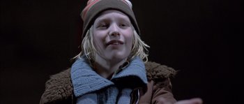 Movie still from “Let the Right One In” (2008), directed by Tomas Alfredson – A young girl with blonde hair wearing a hat and jacket; Close Up shot, Low angle