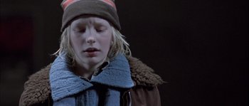 Movie still from “Let the Right One In” (2008), directed by Tomas Alfredson – A young girl wearing a hat and a jacket; Close Up shot, Low angle
