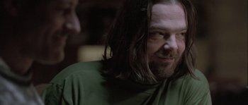 Movie still from “Let the Right One In” (2008), directed by Tomas Alfredson – A person with long hair and a beard; Close Up shot, Over the shoulder angle