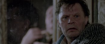 Movie still from “Let the Right One In” (2008), directed by Tomas Alfredson – A person smoking a cigarette in front of another person; Close Up shot, Over the shoulder angle