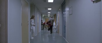Movie still from “Let the Right One In” (2008), directed by Tomas Alfredson – A group of people walking down a long hallway; Extreme Wide shot, High angle