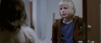 Movie still from “Let the Right One In” (2008), directed by Tomas Alfredson – A young boy is looking at himself in the mirror; Close Up shot, Over the shoulder angle
