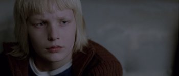 Movie still from “Let the Right One In” (2008), directed by Tomas Alfredson – A person wearing a sweater; Close Up shot, Over the shoulder angle