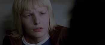 Movie still from “Let the Right One In” (2008), directed by Tomas Alfredson – A person with blond hair; Close Up shot, Over the shoulder angle