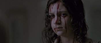 Movie still from “Let the Right One In” (2008), directed by Tomas Alfredson – A woman with blood dripping down her face; Close Up shot, High angle