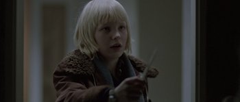 Movie still from “Let the Right One In” (2008), directed by Tomas Alfredson – A young girl holding a pair of scissors; Close Up shot, Over the shoulder angle