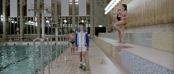 Movie still from “Let the Right One In” (2008), directed by Tomas Alfredson – A boy standing in front of a swimming pool; Wide shot, Over the shoulder angle