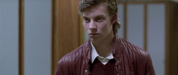 Movie still from “Let the Right One In” (2008), directed by Tomas Alfredson – A young man in a red jacket looking at the camera; Close Up shot, Over the shoulder angle