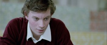 Movie still from “Let the Right One In” (2008), directed by Tomas Alfredson – A person wearing a red shirt; Close Up shot, Over the shoulder angle