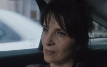 Movie still from “Let the Sunshine In” (2017), directed by Claire Denis – A person sitting in a car; Close Up shot, Over the shoulder angle