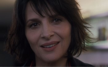 Movie still from “Let the Sunshine In” (2017), directed by Claire Denis – A woman's face with brown eyes; Close Up shot, Over the shoulder angle