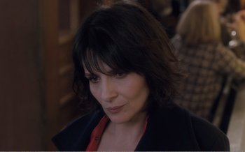 Movie still from “Let the Sunshine In” (2017), directed by Claire Denis – A person wearing a black jacket; Close Up shot, Over the shoulder angle