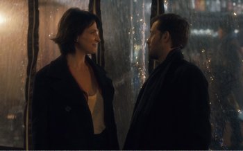 Movie still from “Let the Sunshine In” (2017), directed by Claire Denis – A man and a woman standing next to each other; Medium shot, Over the shoulder angle