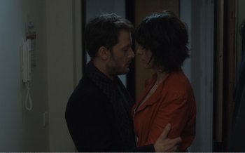 Movie still from “Let the Sunshine In” (2017), directed by Claire Denis – A man and a woman standing next to each other; Medium shot, High angle
