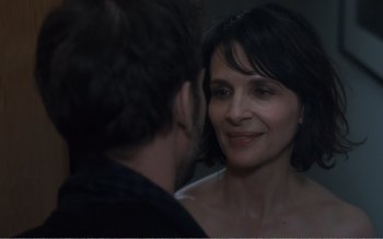 Movie still from “Let the Sunshine In” (2017), directed by Claire Denis – A man and a woman looking at one another in a mirror; Close Up shot, Over the shoulder angle