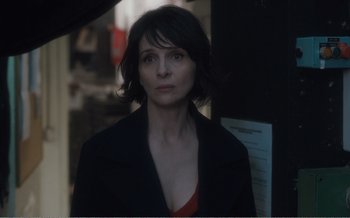 Movie still from “Let the Sunshine In” (2017), directed by Claire Denis – A person with short hair; Close Up shot, Over the shoulder angle