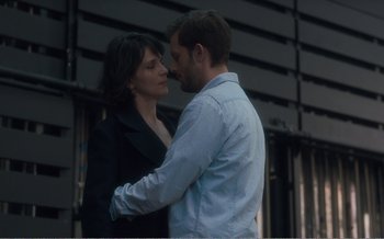 Movie still from “Let the Sunshine In” (2017), directed by Claire Denis – A man and a woman standing next to each other; Medium shot, Over the shoulder angle